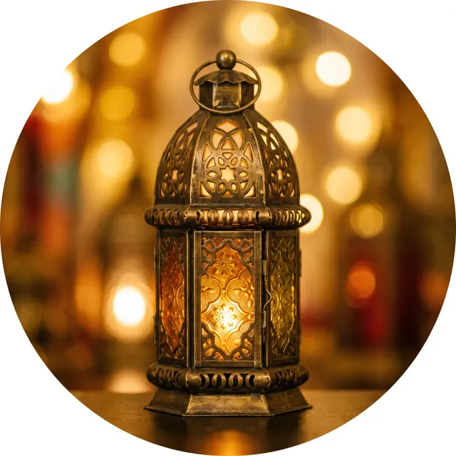 A glowing ornate brass Islamic lantern