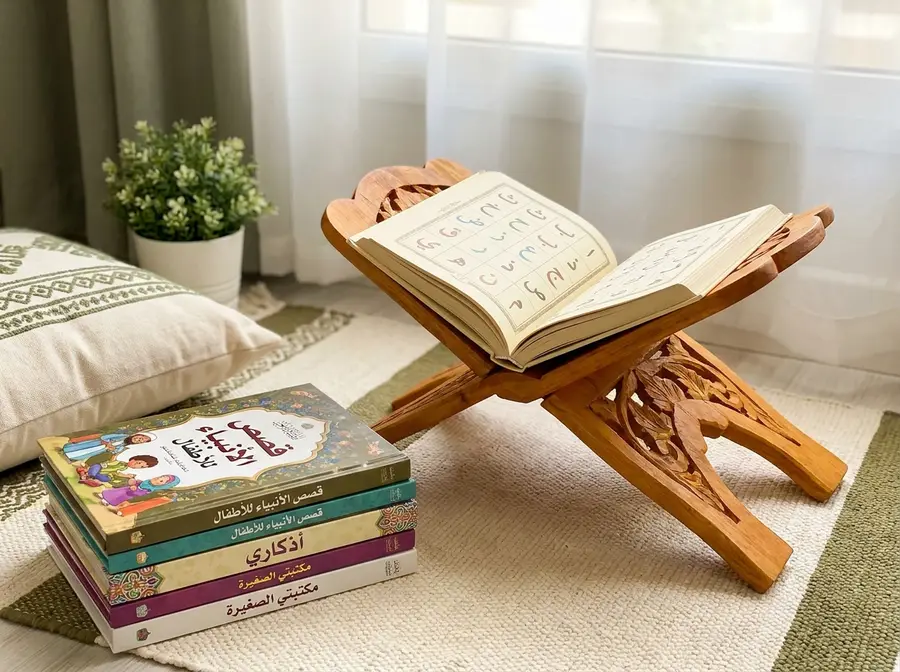 Open Qāʿidah primer on a wooden stand beside children’s Islamic books